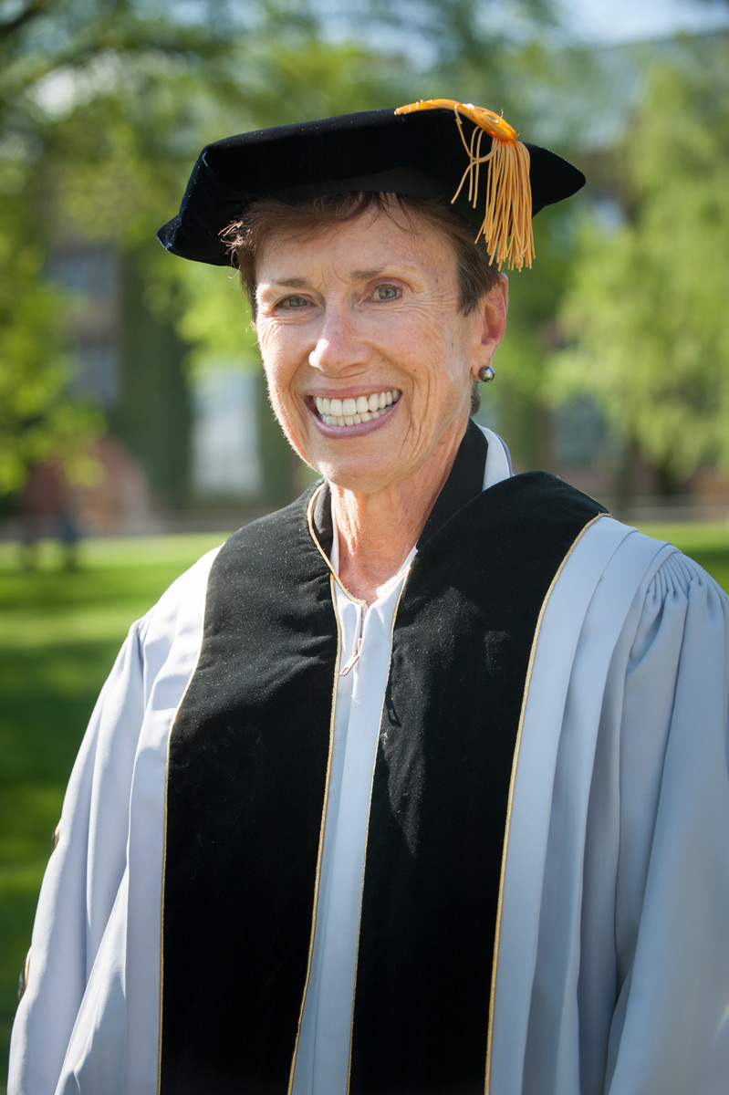 Judith Runstad wearing commencement robes on the Admin Lawn.