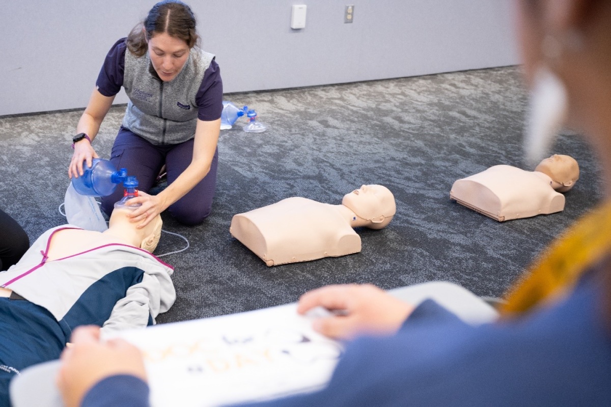Medical student showing students how to perform CPR.