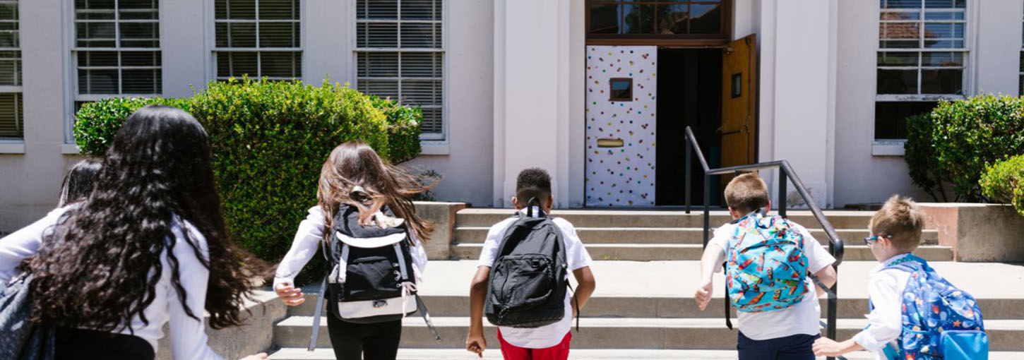 kids running into a school