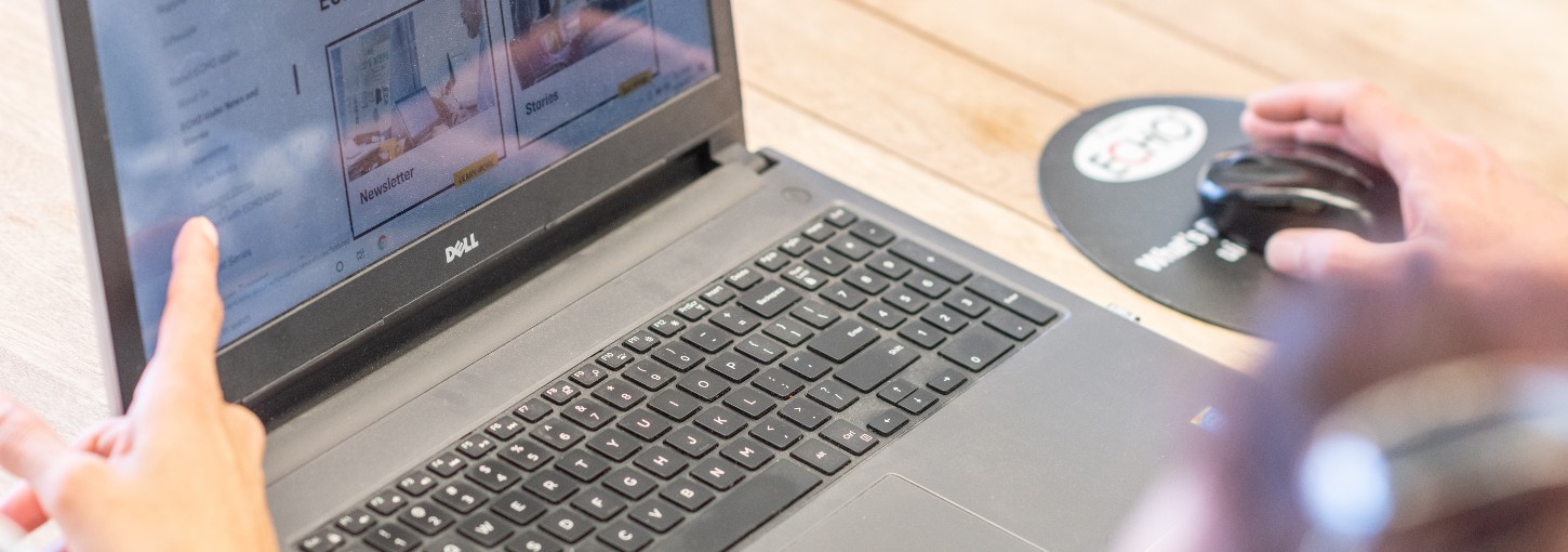 2 people looking at a laptop