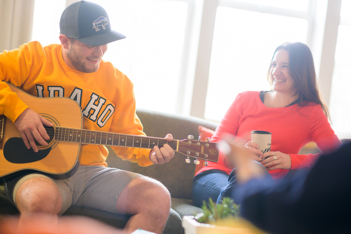 Students relaxing in the shared living area of the Living and Learning Community housing.