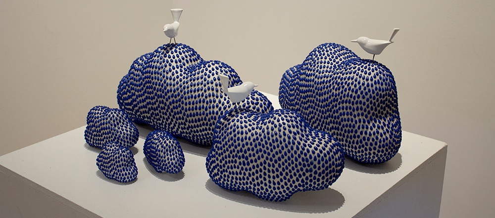 Sculpture exhibit of clouds and birds.