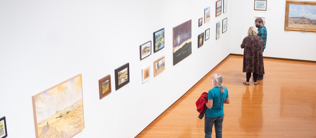 Gallery visitors view entries in the Plein Air exhibit.