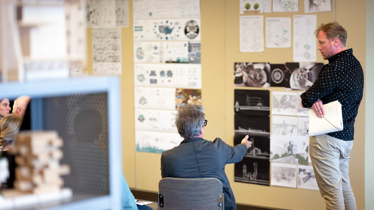 Tyler Schram talks about his master's thesis with faculty and students at the Urban Design Center in Boise.