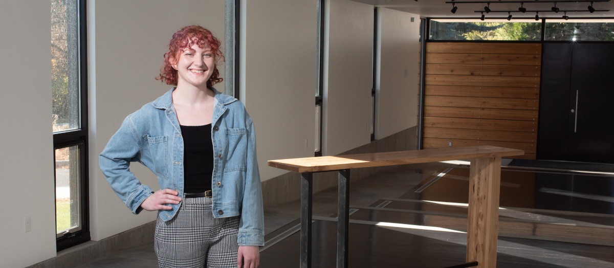 Sonya Fernandes stands beside the table she designed for the University House table competition.