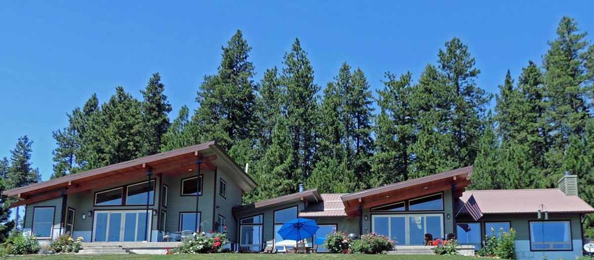 Ranch style home with trees and blue sky in background.