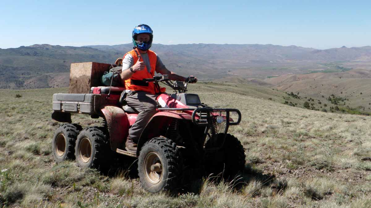Niemeyer poses on an ATV used to cover ground through rangeland.