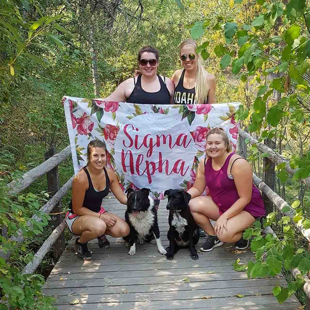 Four women and two dogs outside