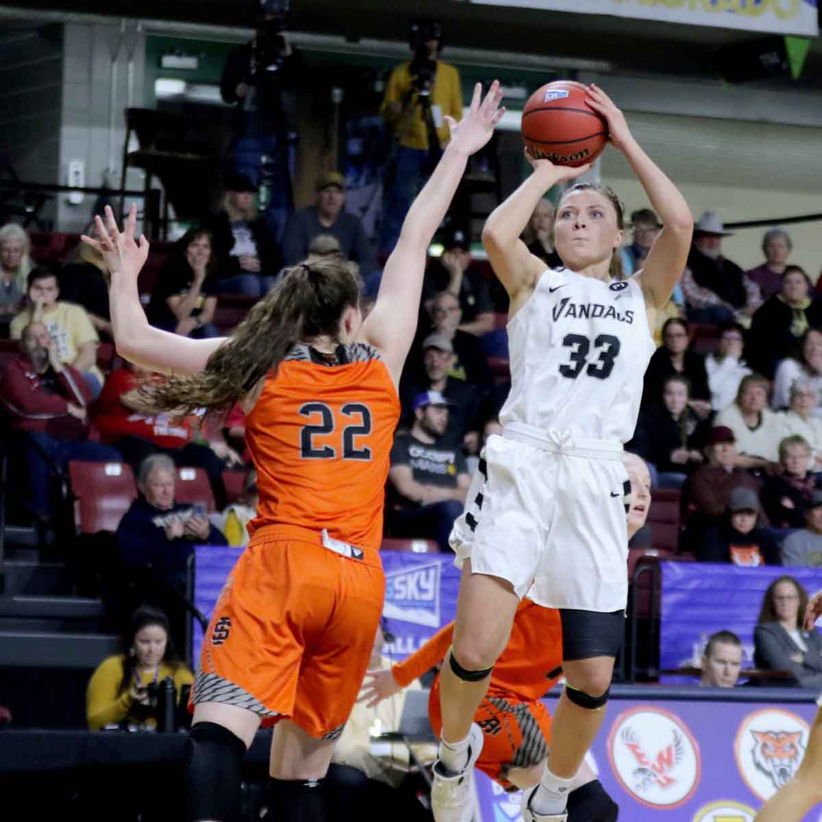 Woman shooting a basketball during a game