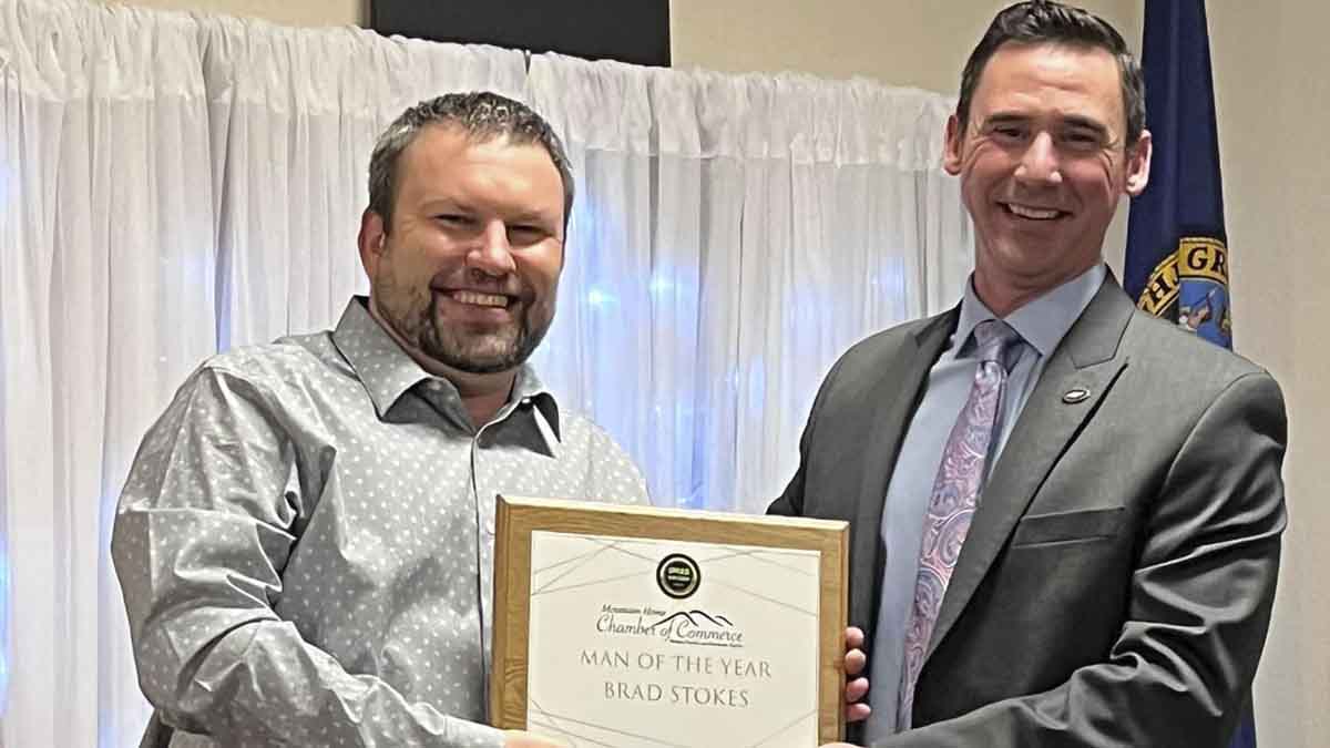 Two men holding an award
