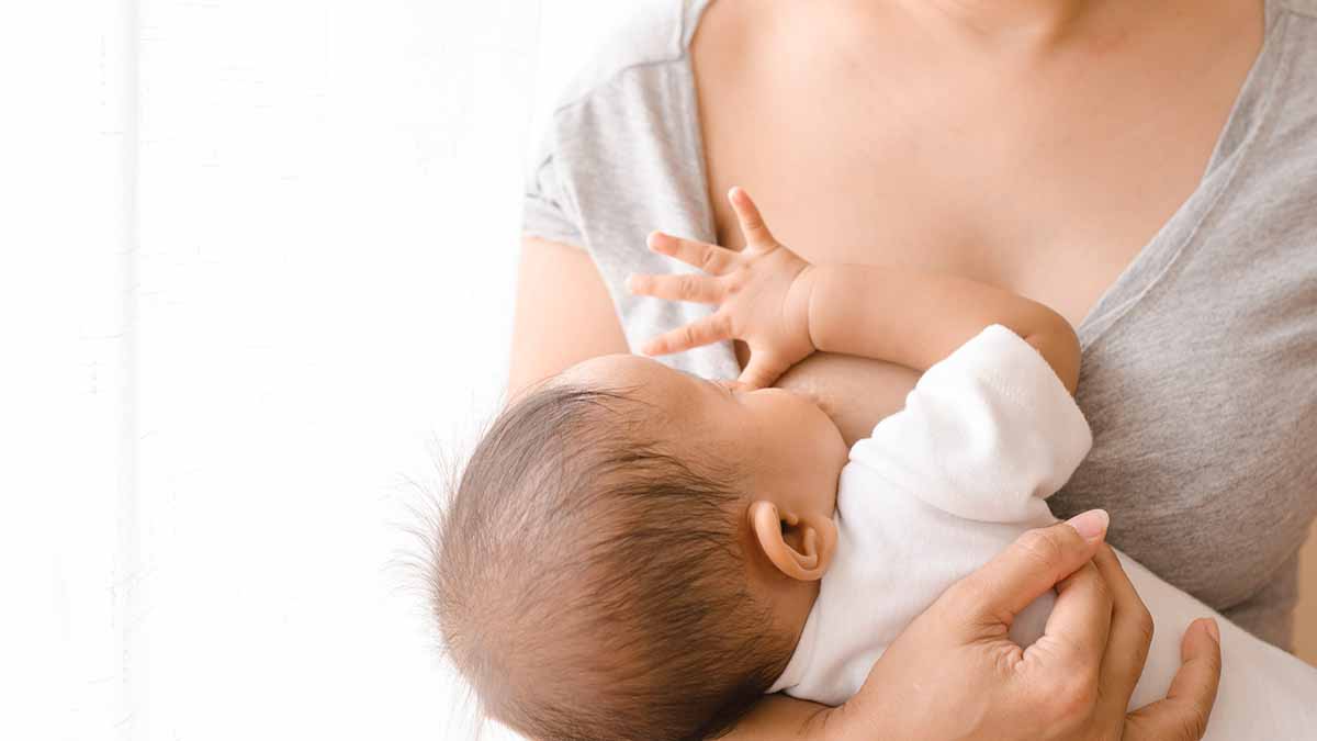 A woman breastfeeding an infant