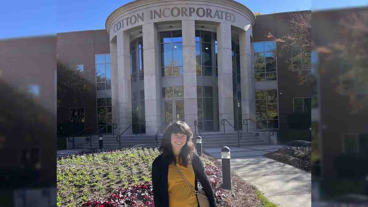 A women in front of Cotton Inc building