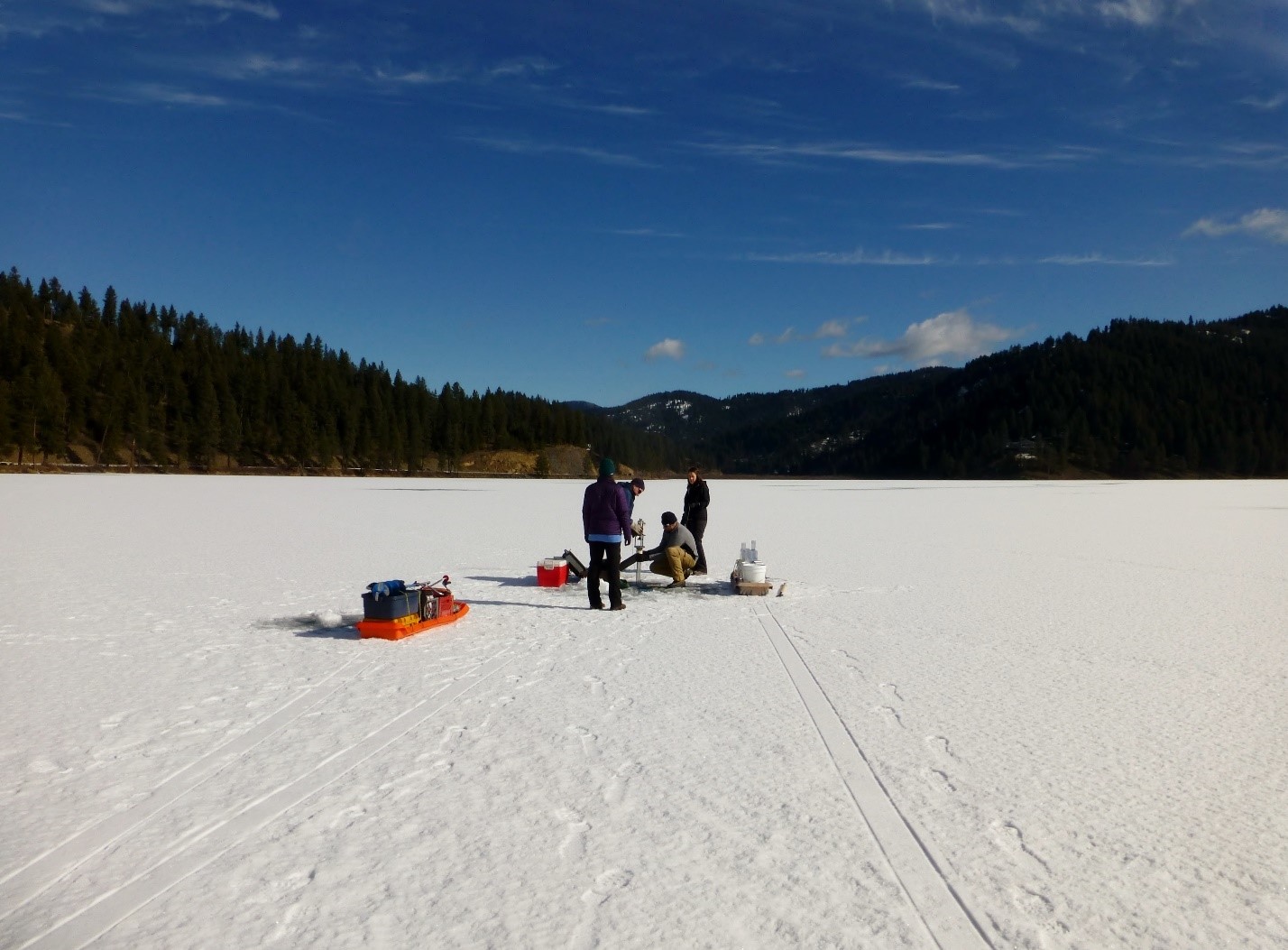 Frank Wilhelm and U of I students on the frozen, snow-covered lake
