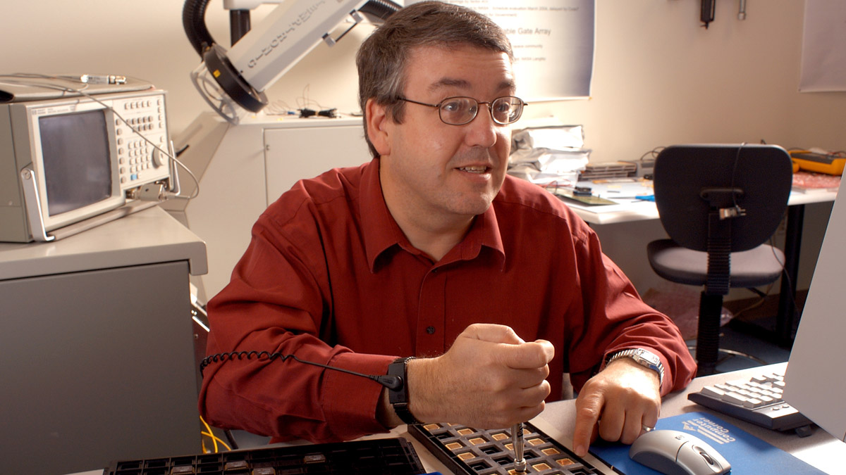 A man working with computer chips.
