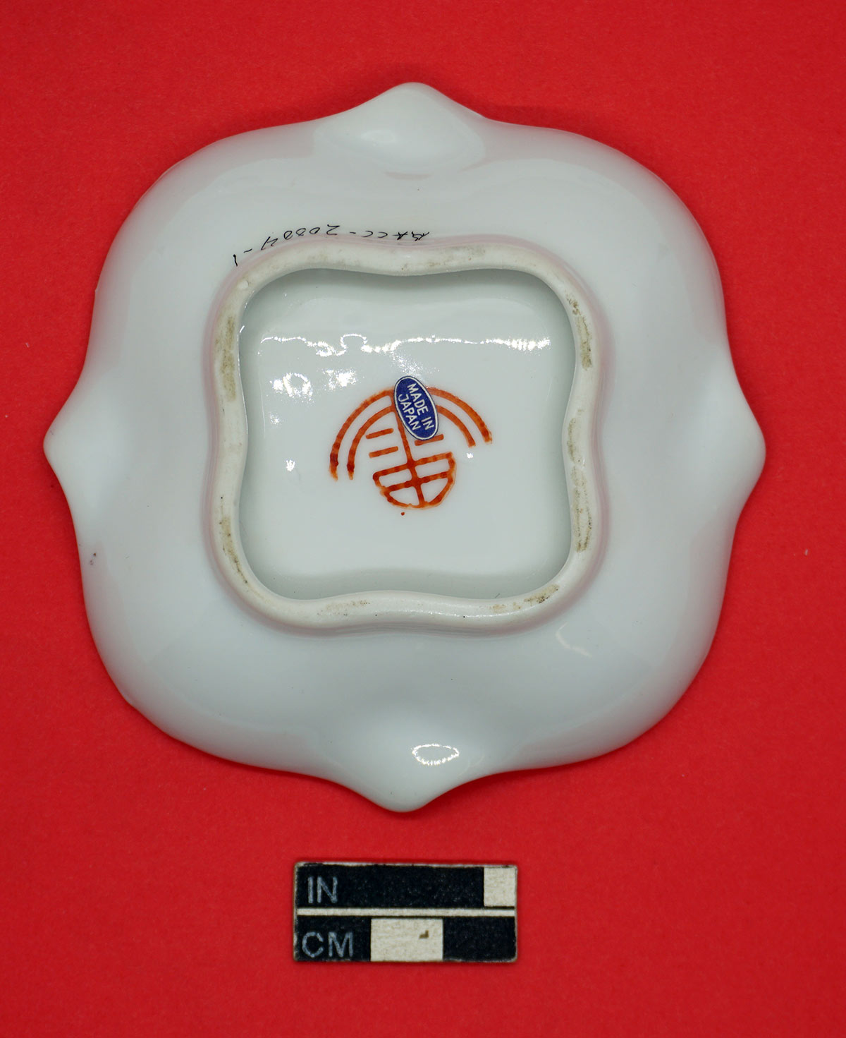 Base of Tea Garden Cafe ashtray, showing logo for F. S. Louie Co., Berkeley, CA, partially covered with "Made in Japan" paper sticker.