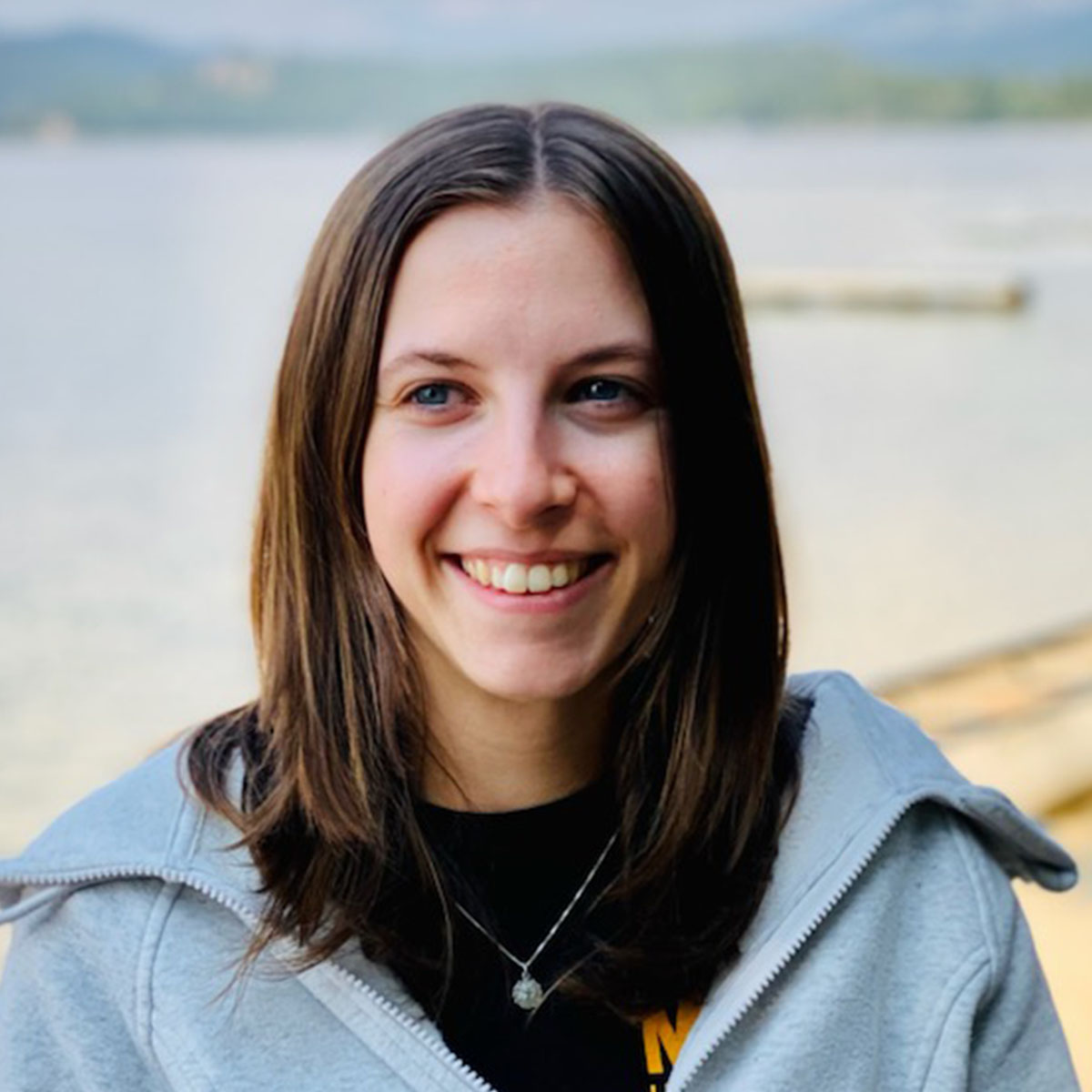 A portrait of Dylan Porter in front of a lake.