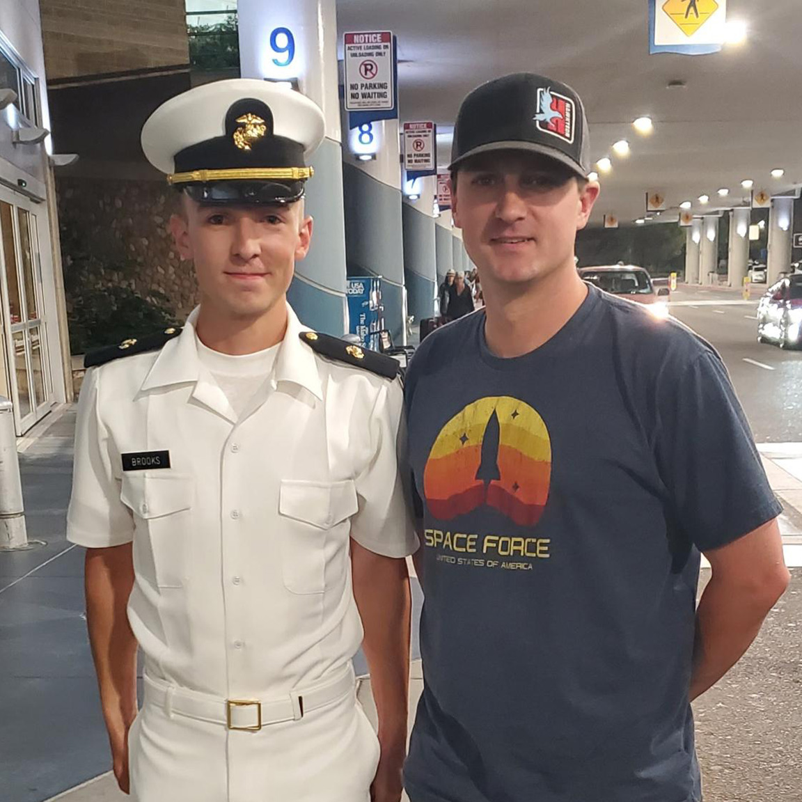 Kaleb Brooks stands with someone at the airport
