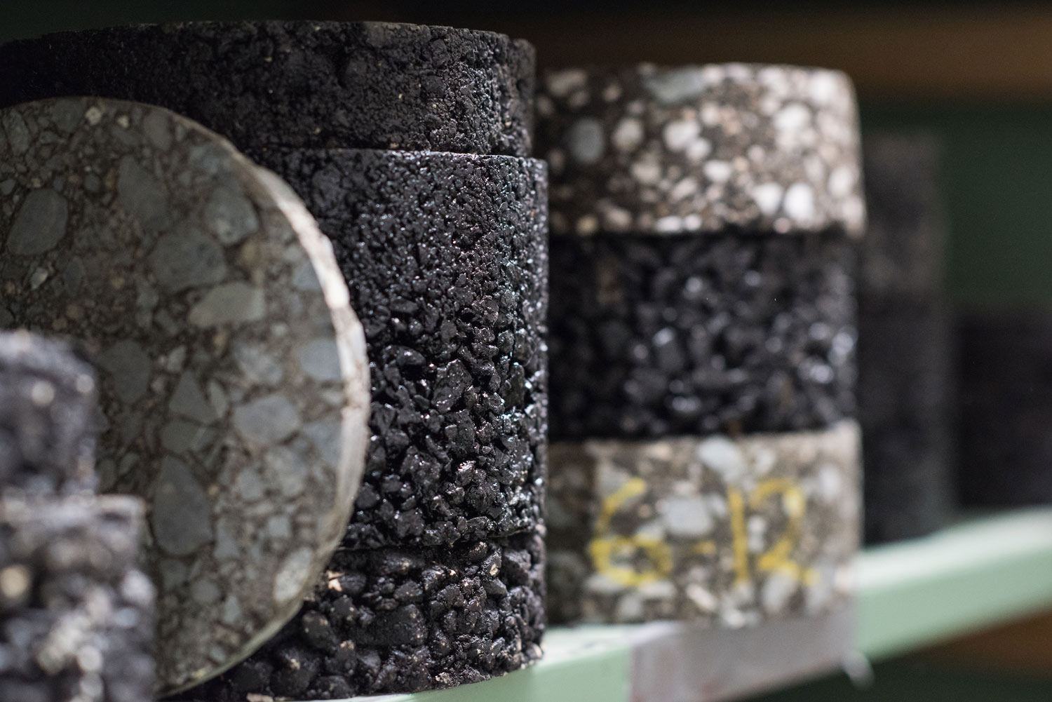 Cylinders of asphalt on a shelf