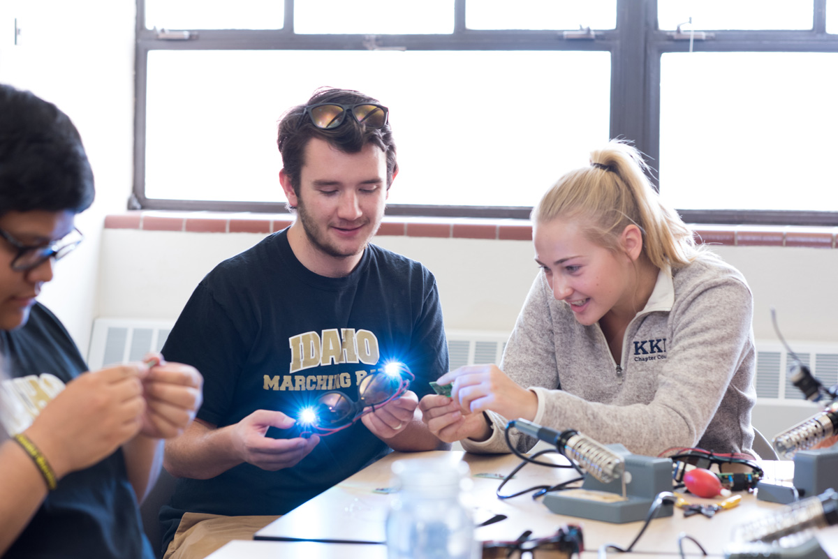 Students attach LEDs and wiring to sunglasses
