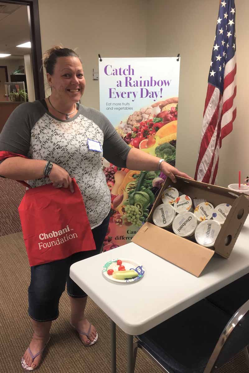 Woman holding box of Chobani yogurt