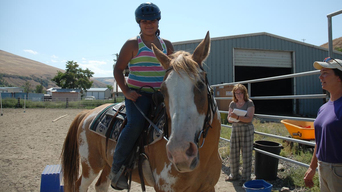 Child on a horse participating in the 4-H horsemanship program
