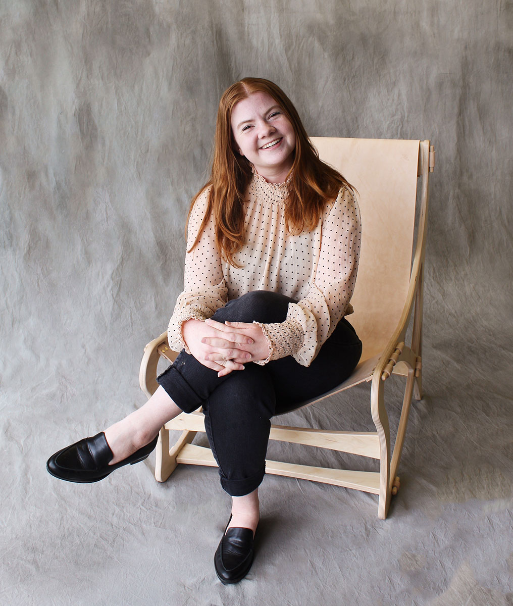 Woman sitting in chair.