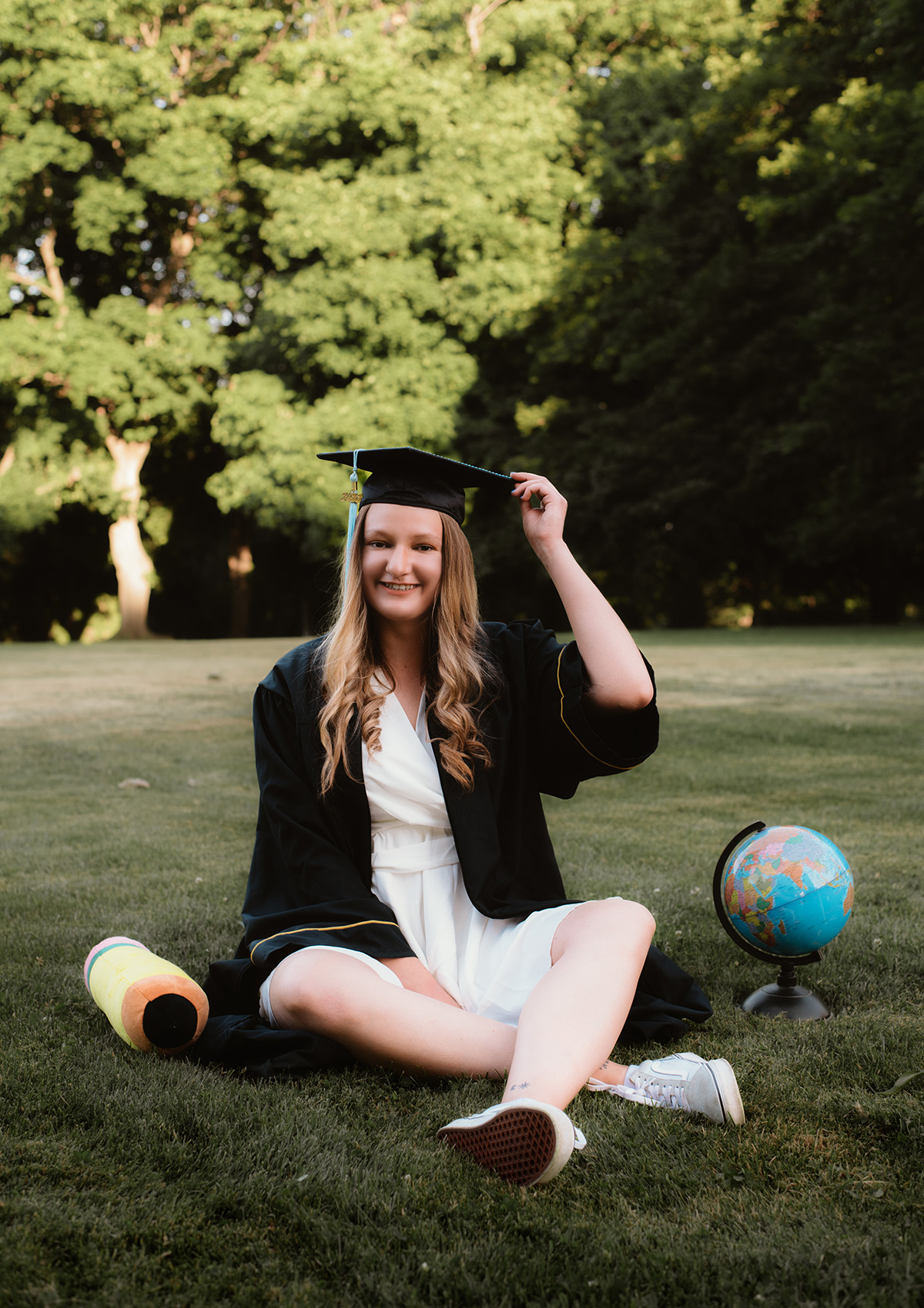 Woman sitting on lawn with globe.