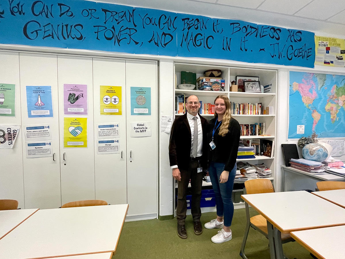 Man and woman standing in classroom.