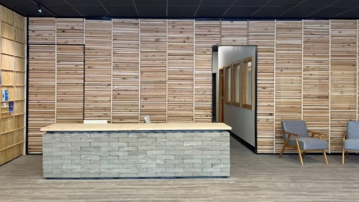 Brick desk and wood walls behind it.