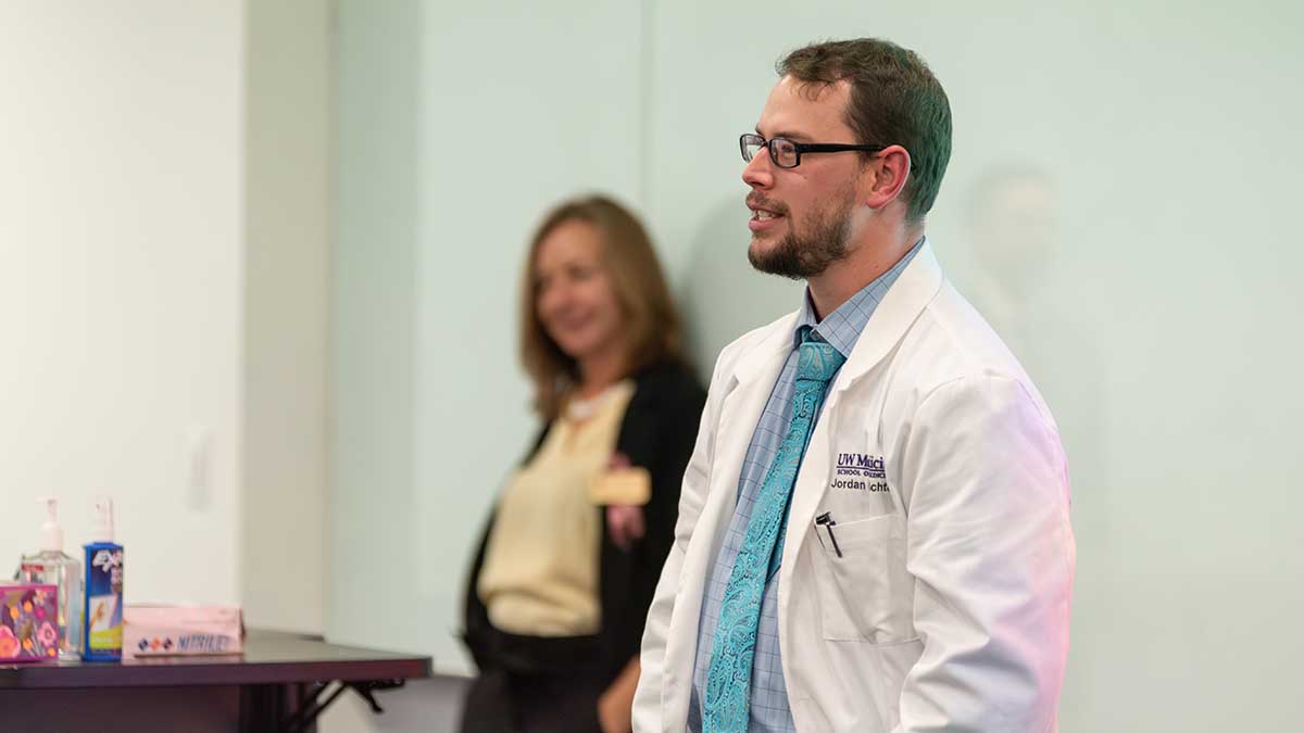 Jordan Richter stands in front of screen.