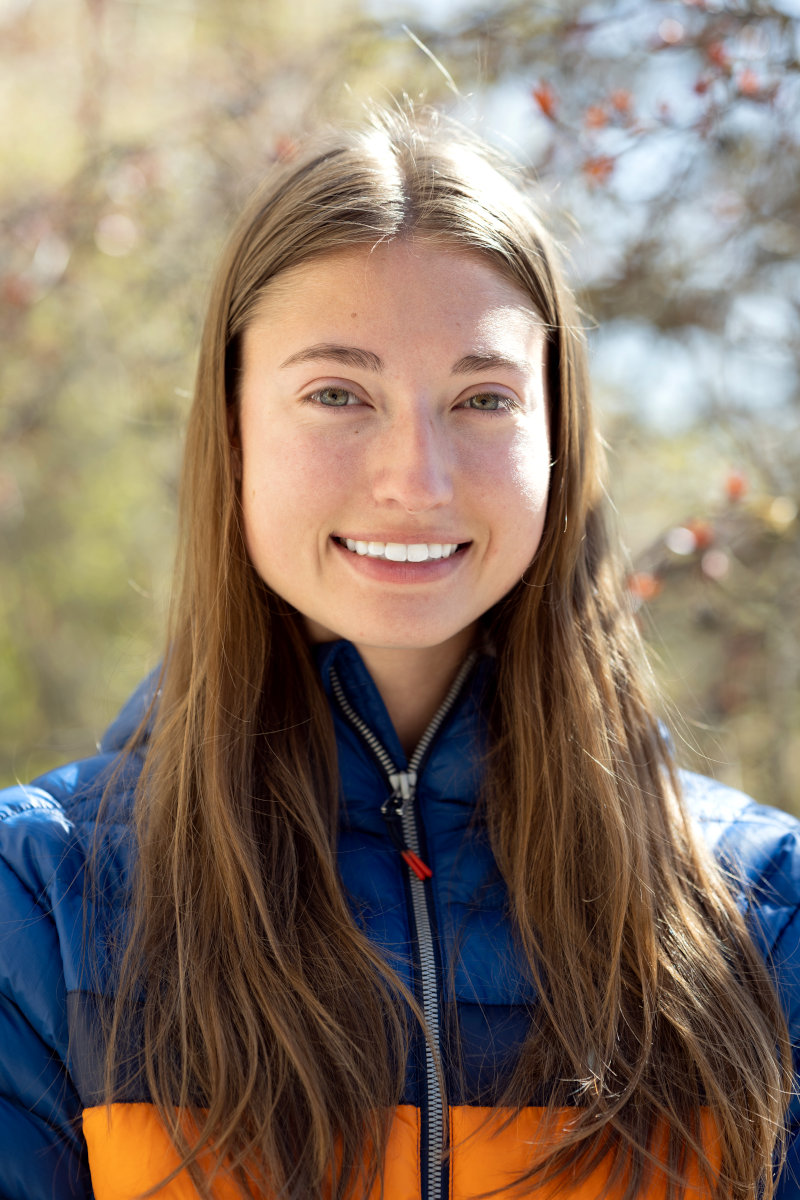 Smiling woman in puffy winter jacket.