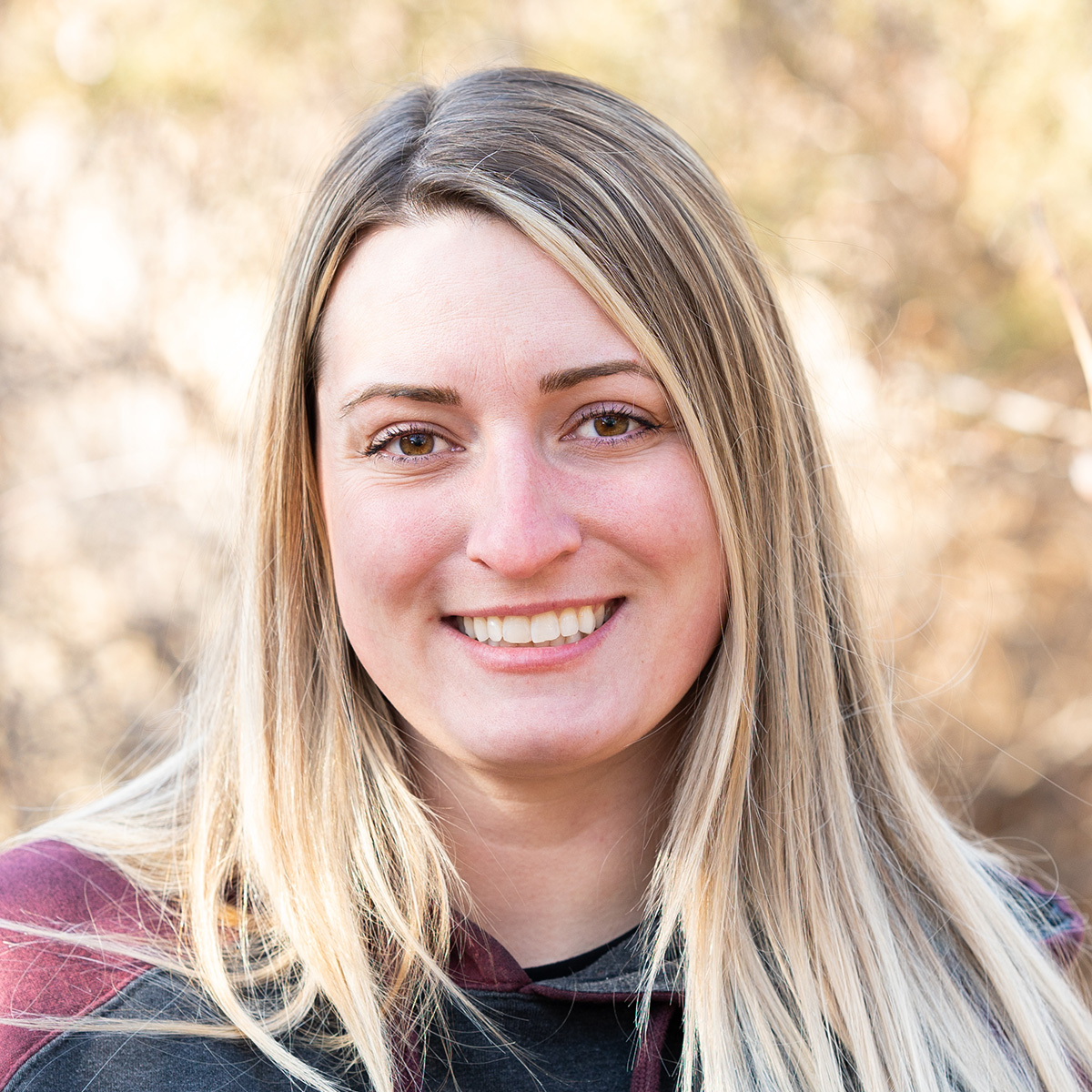 Smiling woman with long hair.