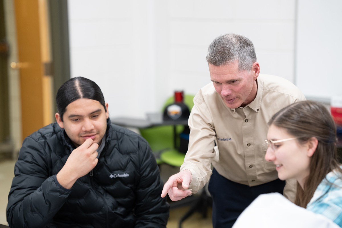 Man interacts with students in a classroom