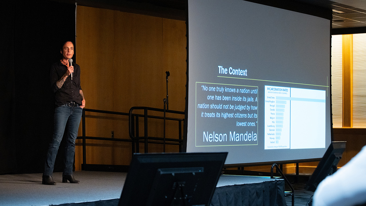 Omi Hodwitz speaks on stage.