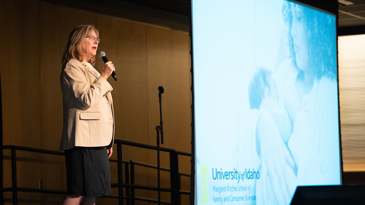 Shelley McGuire speaks on stage.