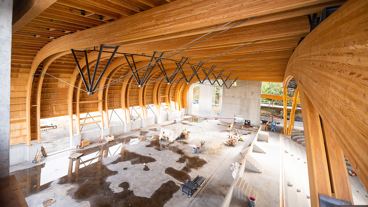 Workers construct the wooden interior of the ICCU Arena.